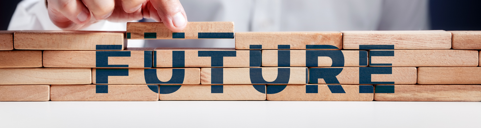 Image showing someone picking a wooden block showing the words 'future' in capitals